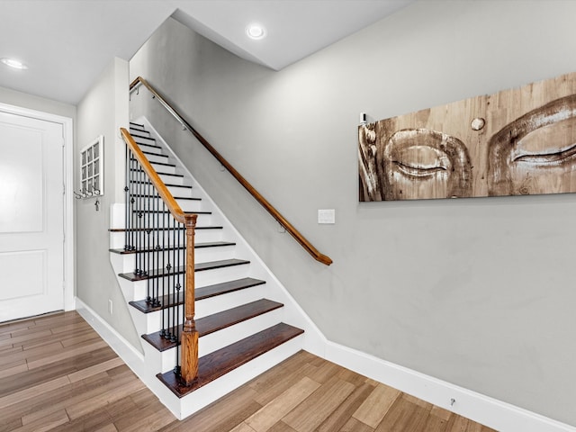 staircase with hardwood / wood-style flooring