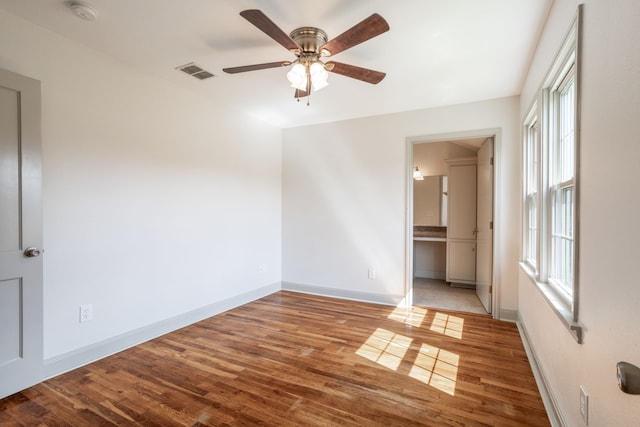 empty room featuring ceiling fan and hardwood / wood-style floors