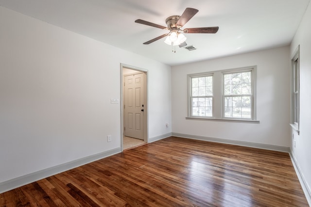 spare room with hardwood / wood-style flooring and ceiling fan