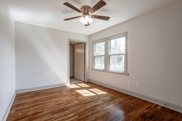 empty room with ceiling fan and hardwood / wood-style floors