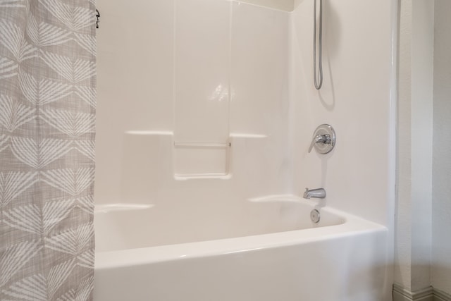 bathroom with bathing tub / shower combination