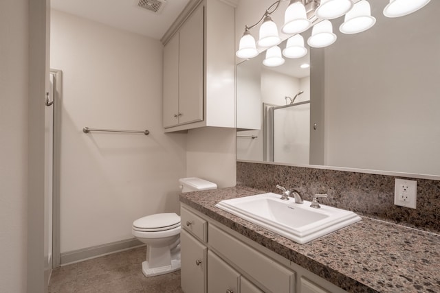 bathroom with toilet, tile patterned flooring, an enclosed shower, and vanity