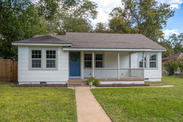 ranch-style house with a front lawn and covered porch