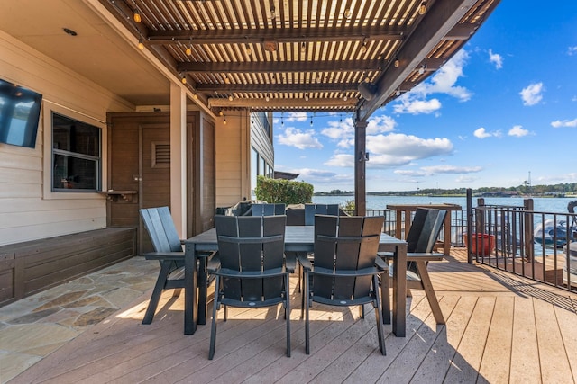 wooden deck featuring a pergola and a water view