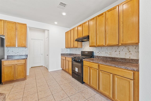 kitchen with black gas range oven, tasteful backsplash, light tile patterned floors, and a textured ceiling