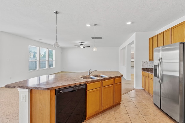 kitchen featuring an island with sink, stainless steel fridge, sink, decorative light fixtures, and dishwasher