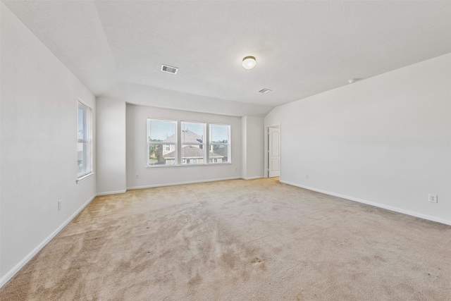 unfurnished room featuring light carpet