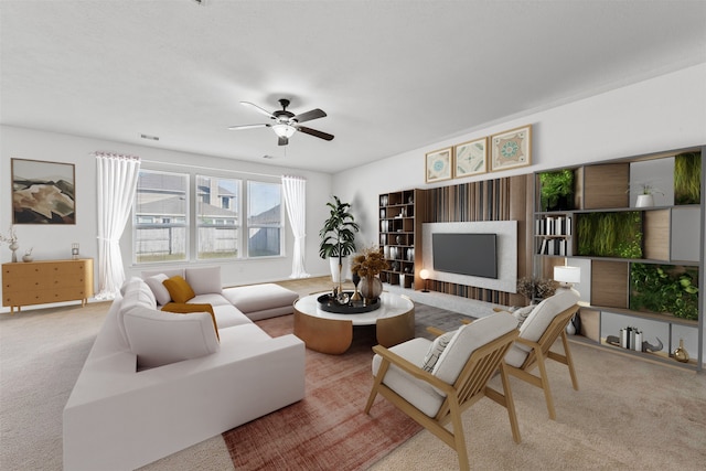 carpeted living room with ceiling fan