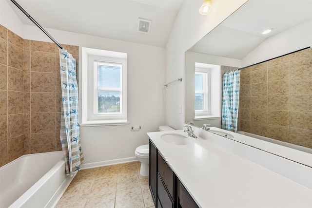 full bathroom featuring a wealth of natural light, vaulted ceiling, vanity, and toilet