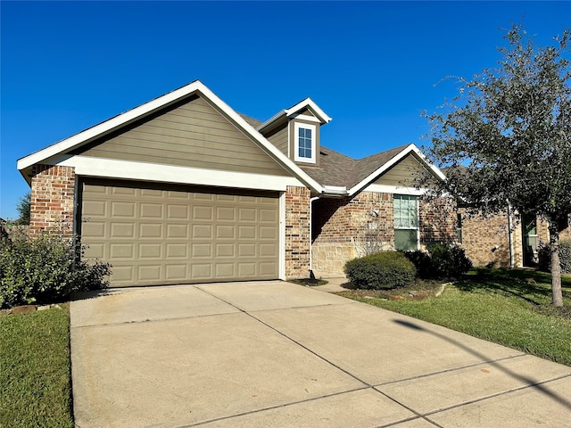 view of front of house with a front yard and a garage