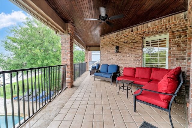 view of patio featuring outdoor lounge area, a fenced in pool, a balcony, and ceiling fan