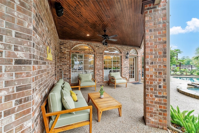 view of patio with ceiling fan and a fenced in pool