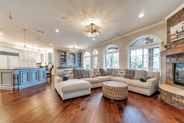 living room featuring ornamental molding, wood-type flooring, and a textured ceiling