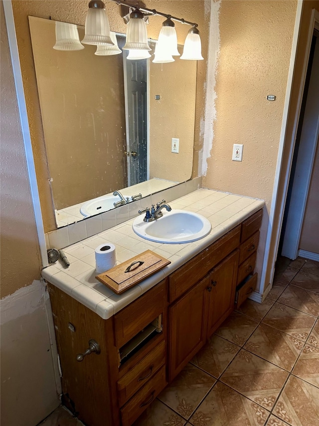 bathroom featuring tile patterned flooring and vanity