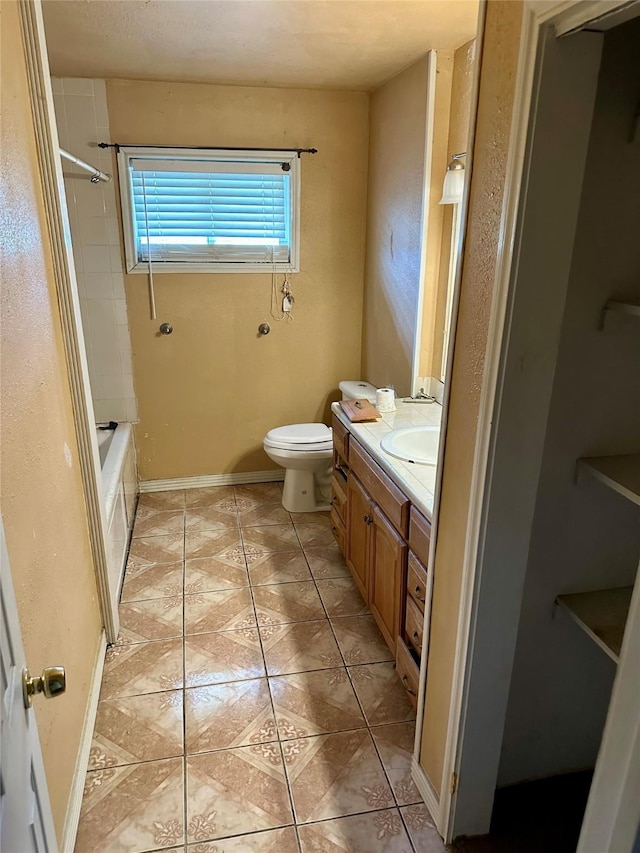 full bathroom featuring tile patterned flooring, vanity, toilet, and tiled shower / bath