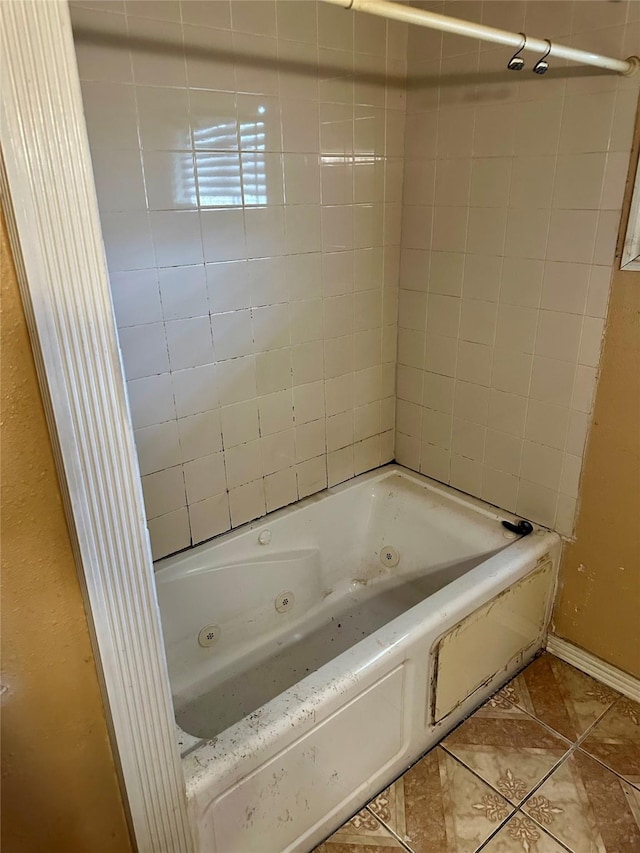 bathroom with tile patterned floors and tiled shower / bath combo