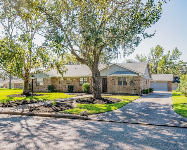 ranch-style home featuring a front lawn and a garage