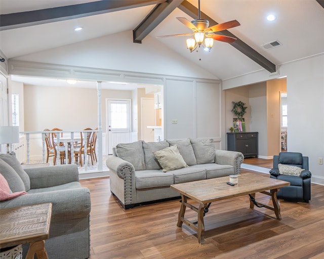 living room featuring ceiling fan, lofted ceiling with beams, and hardwood / wood-style flooring