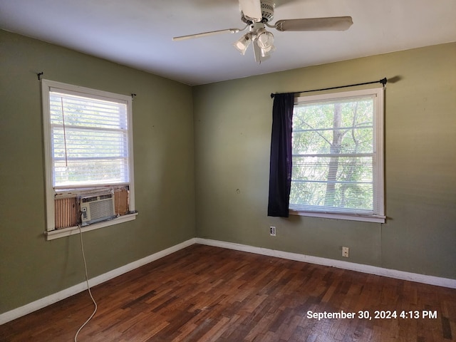 spare room with ceiling fan, cooling unit, and dark hardwood / wood-style flooring