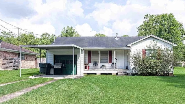 view of front of home with a garage, a porch, and a front yard