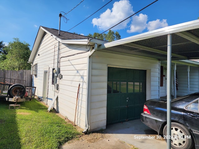 view of side of property with a lawn and a garage