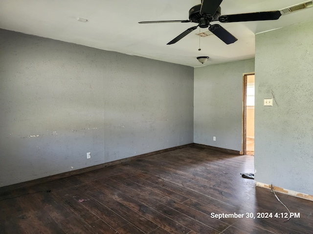 unfurnished room featuring ceiling fan and dark hardwood / wood-style floors