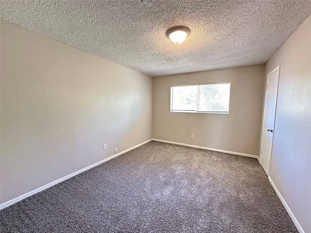 carpeted spare room featuring a textured ceiling