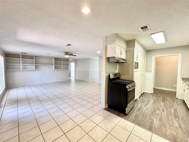 kitchen with ceiling fan, white cabinets, appliances with stainless steel finishes, and a textured ceiling