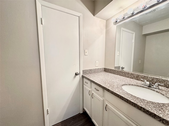 bathroom featuring vanity and hardwood / wood-style floors