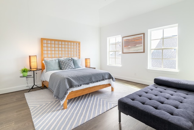 bedroom featuring hardwood / wood-style flooring and multiple windows