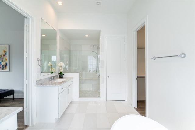 bathroom featuring vanity and a shower with door