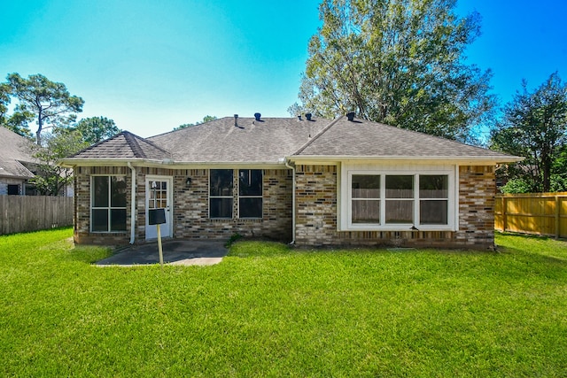 back of house featuring a patio and a lawn