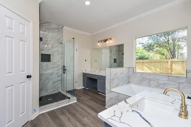 bathroom featuring vanity, wood-type flooring, ornamental molding, and plus walk in shower