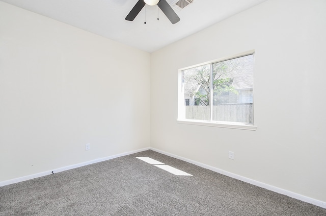 carpeted spare room with ceiling fan