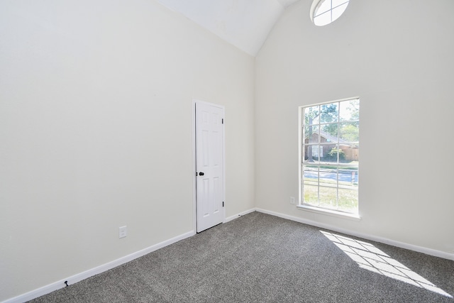 unfurnished room with carpet and high vaulted ceiling