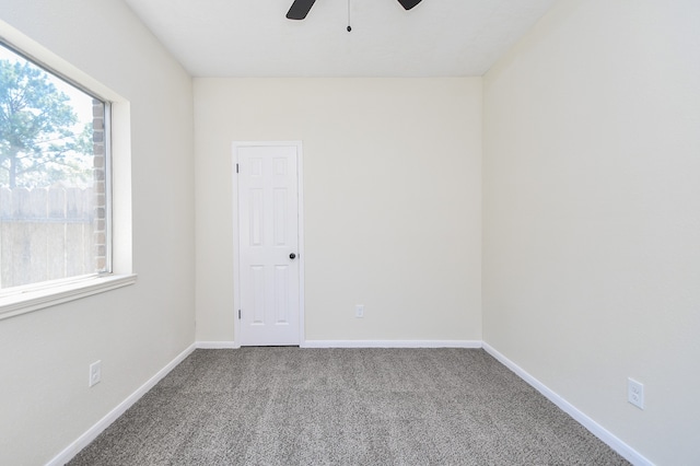 carpeted spare room with plenty of natural light and ceiling fan