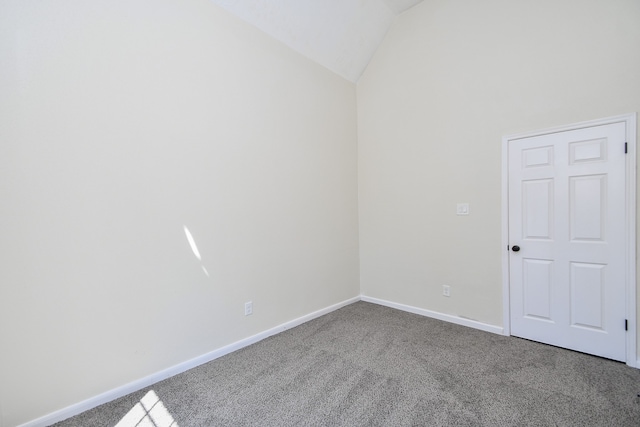 empty room featuring carpet flooring and vaulted ceiling