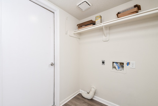 laundry area featuring washer hookup, electric dryer hookup, dark hardwood / wood-style floors, and a textured ceiling