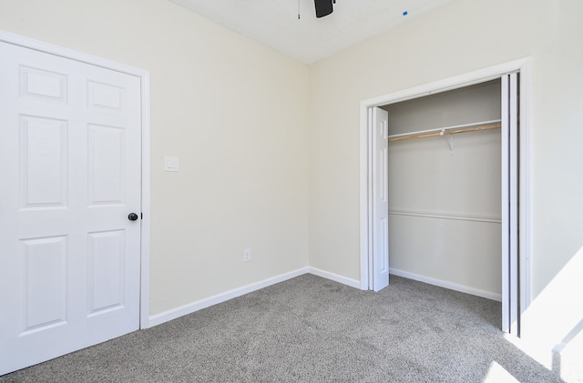 unfurnished bedroom with carpet flooring, ceiling fan, and a closet