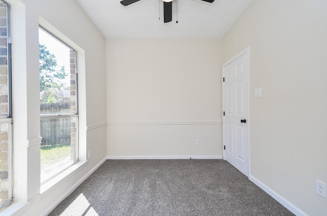 carpeted empty room featuring ceiling fan and a healthy amount of sunlight