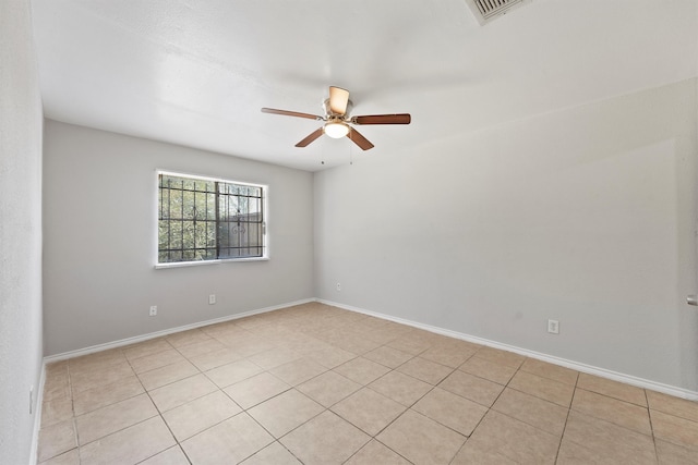 unfurnished room with ceiling fan and light tile patterned floors