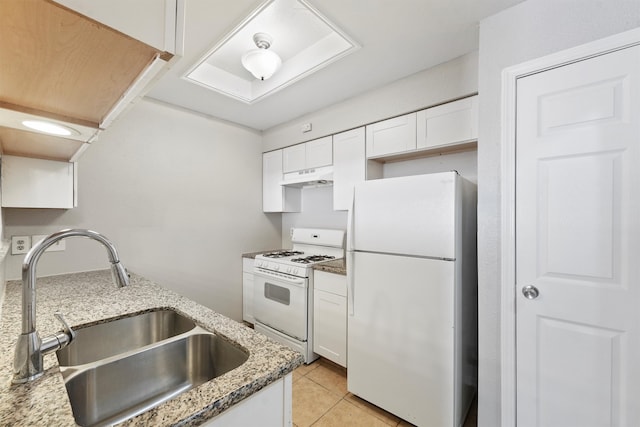 kitchen featuring white appliances, custom range hood, sink, light stone countertops, and white cabinets