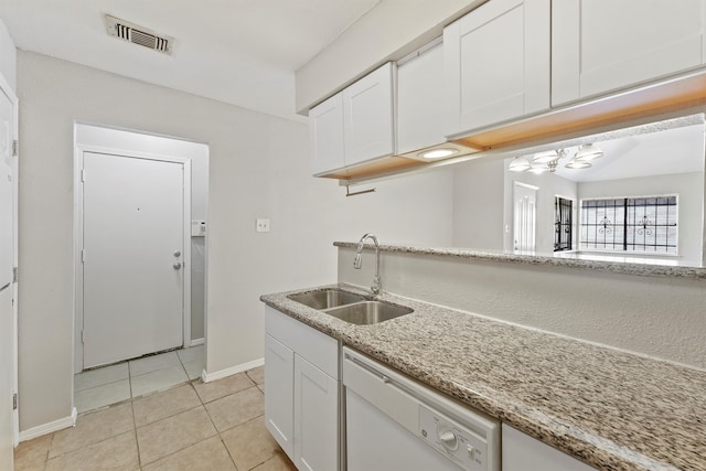 kitchen with white cabinets, white dishwasher, light stone countertops, and sink