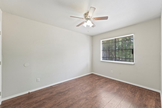 empty room with ceiling fan and dark hardwood / wood-style floors