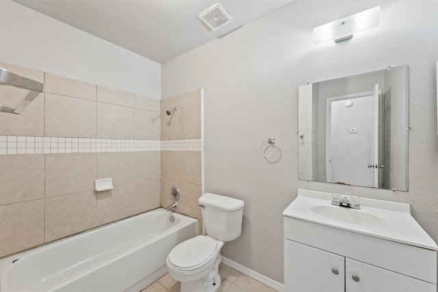 full bathroom featuring vanity, tile patterned flooring, toilet, and tiled shower / bath combo