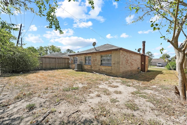 rear view of property with central AC