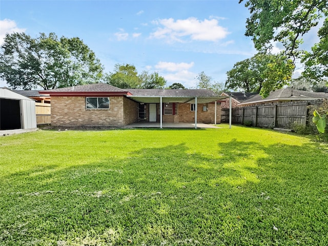 back of house with a lawn and a patio area