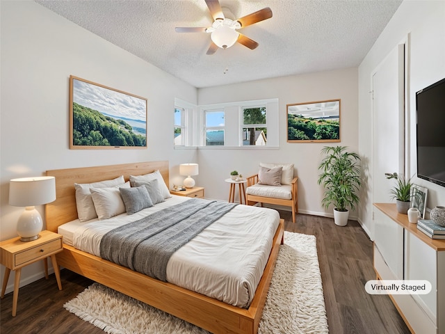 bedroom with dark wood-type flooring, a textured ceiling, and ceiling fan