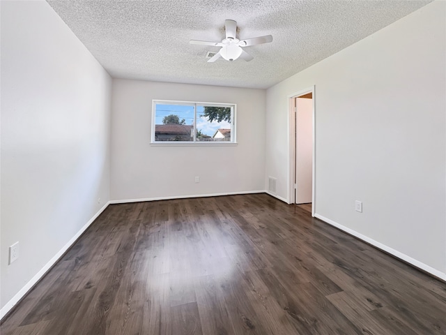 unfurnished room featuring ceiling fan, dark wood-type flooring, and a textured ceiling