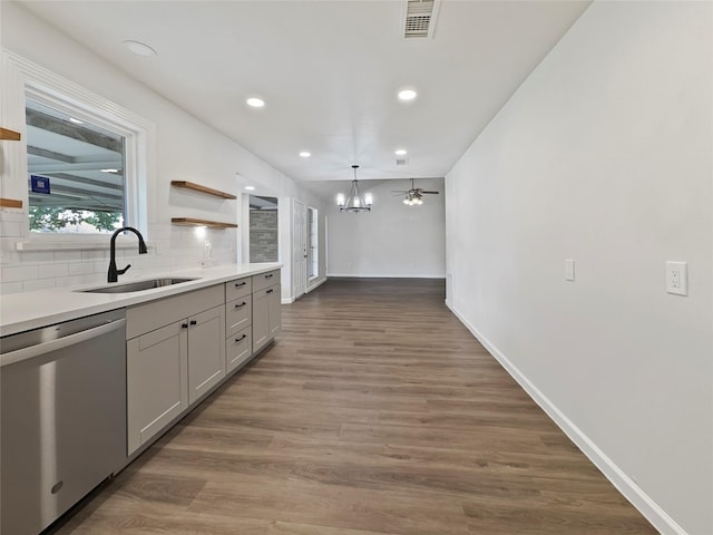602 Meadowglen Dr, Baytown, TX 77521 - kitchen featuring stainless steel dishwasher, visible vents, wood finished floors, a sink, and decorative backsplash